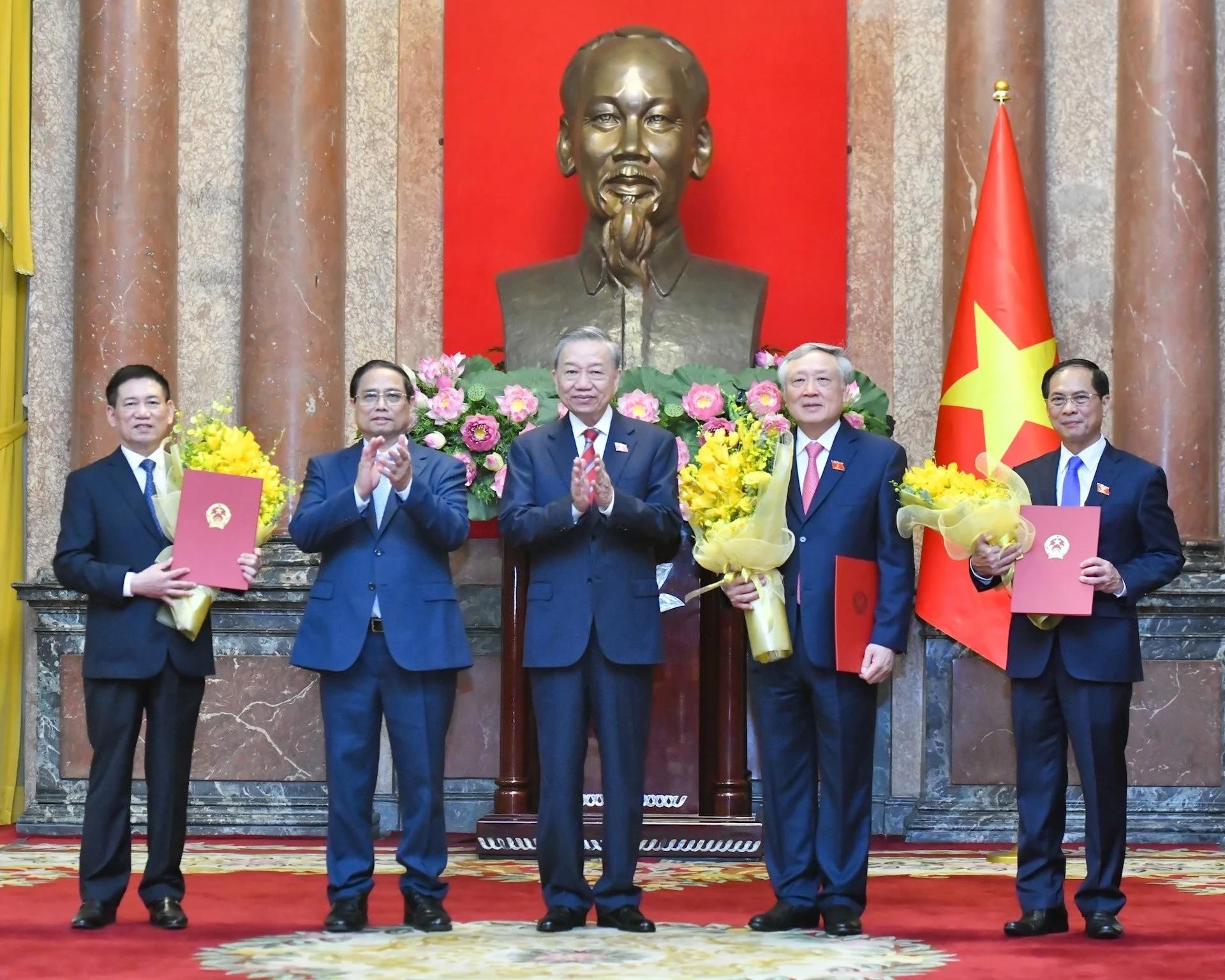 Tổng Bí thư, Chủ tịch nước Tô Lâm trao Quyết định bổ nhiệm, Thủ tướng Phạm Minh Chính tặng hoa chúc mừng các Phó Thủ tướng Nguyễn Hòa Bình, Bùi Thanh Sơn và Hồ Đức Phớc. Ảnh: TTXVN