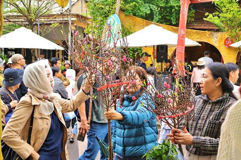 Người dân phấn khởi mua hoa về chưng, làm cho không khí Tết thêm sôi động. Ảnh: Diễm Phúc